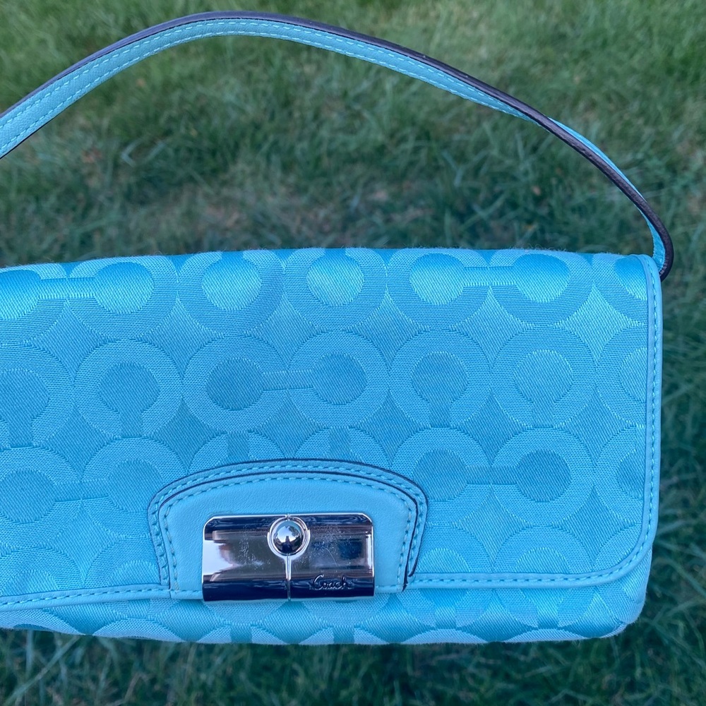 Blue Coach handbag with strap and magnetic closure